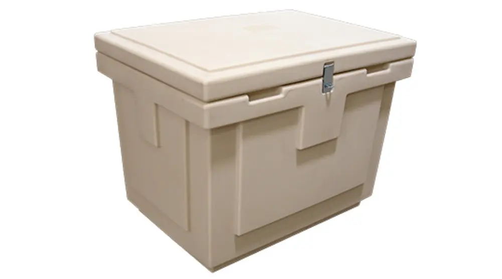 A large tan cooler sitting on top of a table.