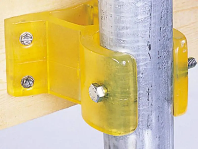 A yellow plastic clip on the side of a metal pole.